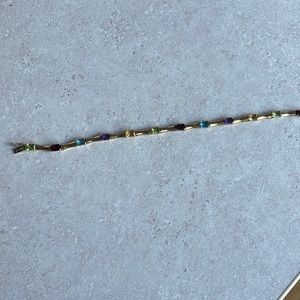 A beautiful 14K gold bracelet with multi-color stones.